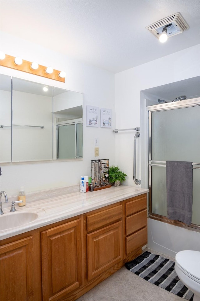 full bath featuring vanity, toilet, shower / bath combination with glass door, and visible vents