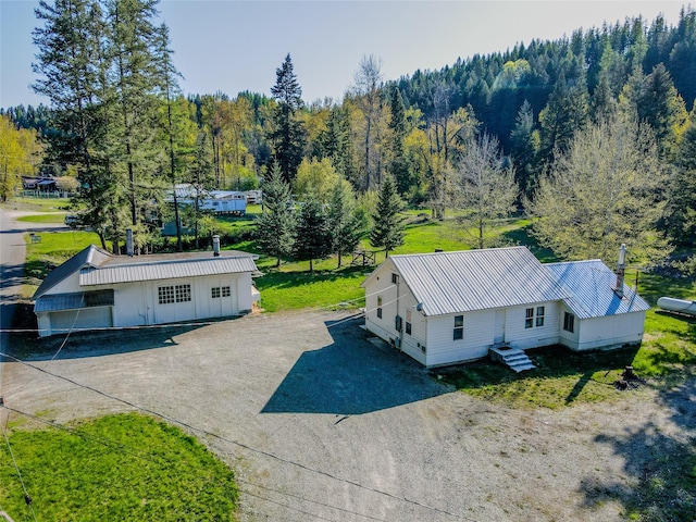 drone / aerial view with a wooded view