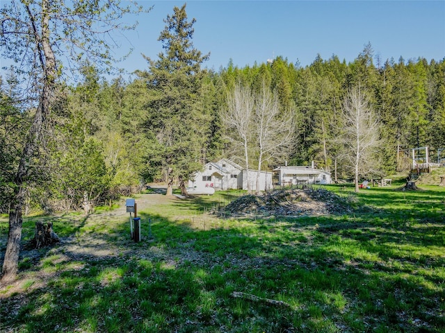 view of yard with a forest view