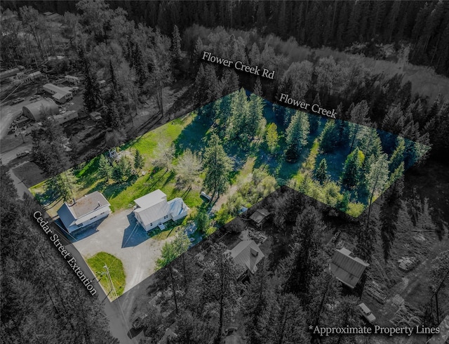 birds eye view of property with a wooded view
