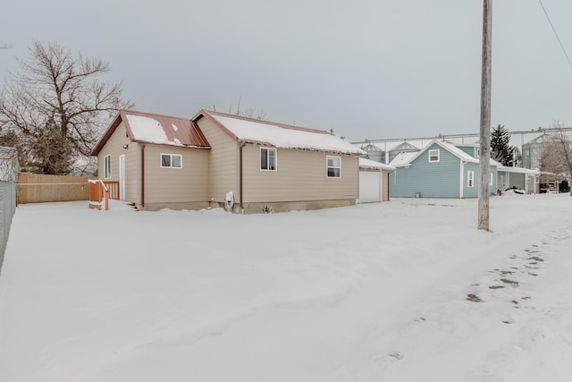 view of snow covered rear of property