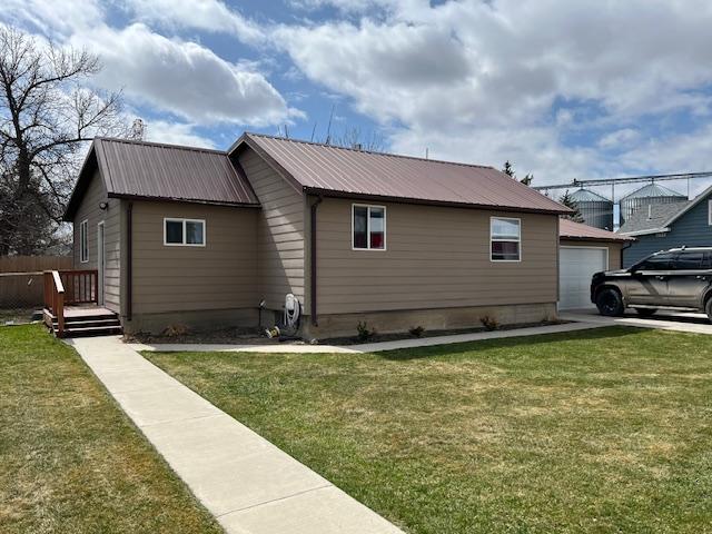 420 1st Ave S, Fairfield, MT 59436 - snow covered rear of property featuring fence and a garage