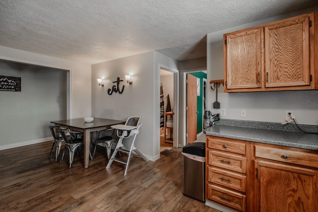 kitchen featuring dark hardwood / wood-style flooring and a textured ceiling