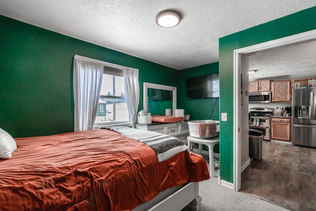 bedroom with wood-type flooring, stainless steel fridge with ice dispenser, and a textured ceiling