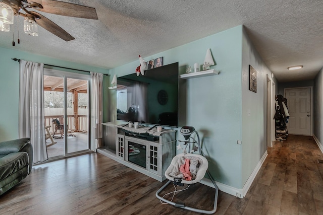 living room featuring hardwood / wood-style floors, a textured ceiling, and ceiling fan