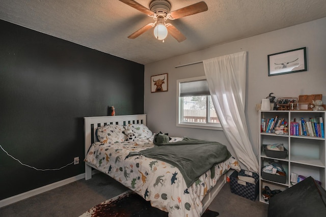 bedroom featuring ceiling fan, carpet floors, and a textured ceiling