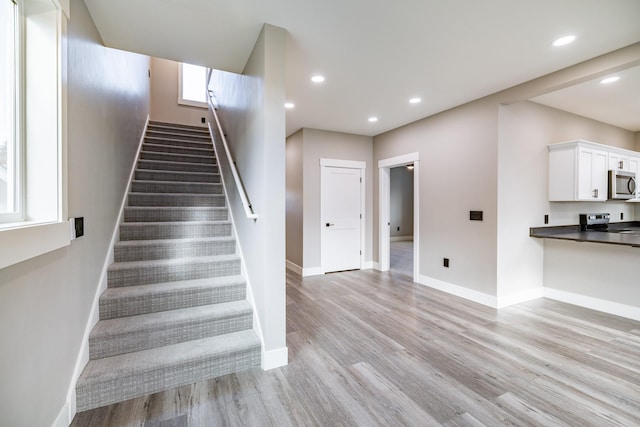 staircase featuring hardwood / wood-style flooring