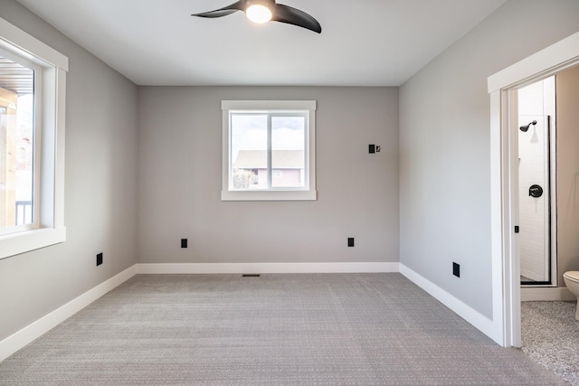 unfurnished room featuring light colored carpet and ceiling fan