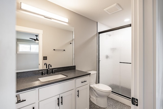 bathroom featuring vanity, toilet, a shower with shower door, and a baseboard heating unit