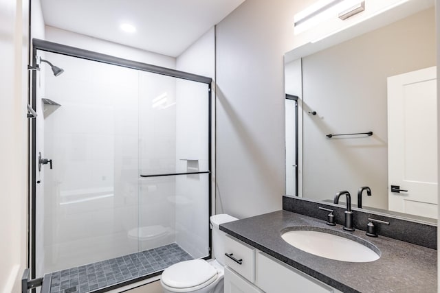 bathroom with vanity, toilet, and walk in shower