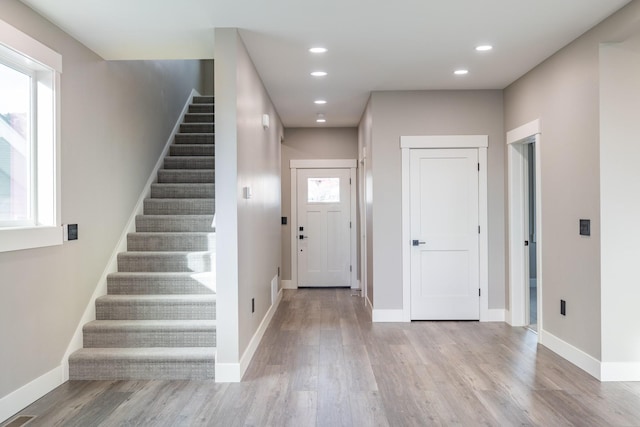 foyer entrance with light hardwood / wood-style floors