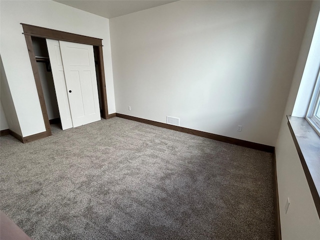 unfurnished bedroom with carpet floors and a closet