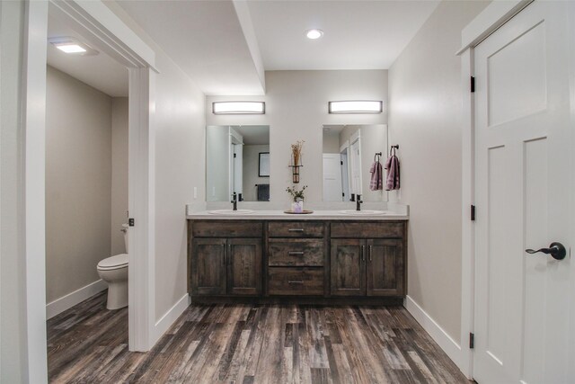 bathroom featuring hardwood / wood-style floors, vanity, and toilet