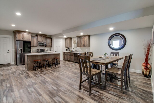 dining room with sink and hardwood / wood-style flooring