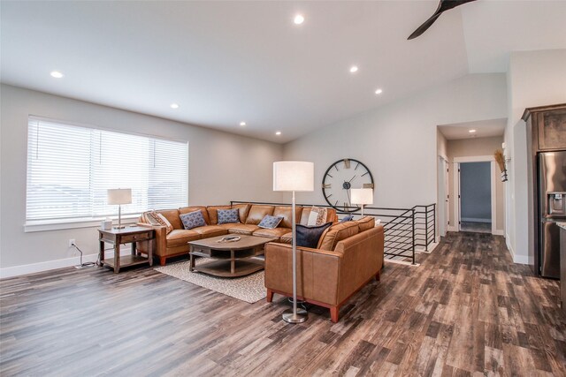 living room featuring dark hardwood / wood-style flooring and lofted ceiling