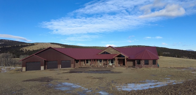 view of front of home featuring a mountain view and a garage