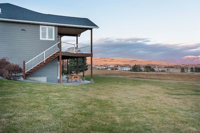 yard at dusk featuring a mountain view