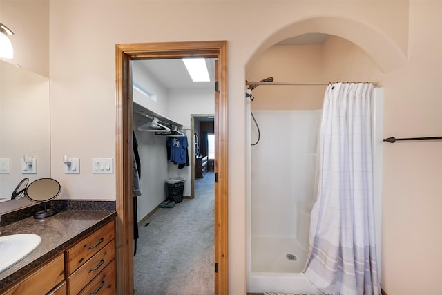 bathroom featuring vanity and curtained shower