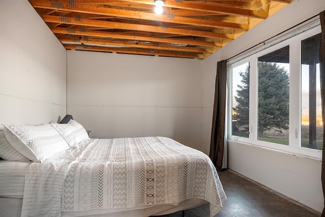 bedroom featuring concrete flooring