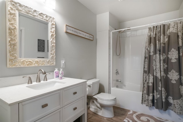 full bathroom featuring vanity, hardwood / wood-style floors, shower / bathtub combination with curtain, and toilet