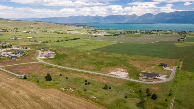 aerial view featuring a rural view and a water and mountain view