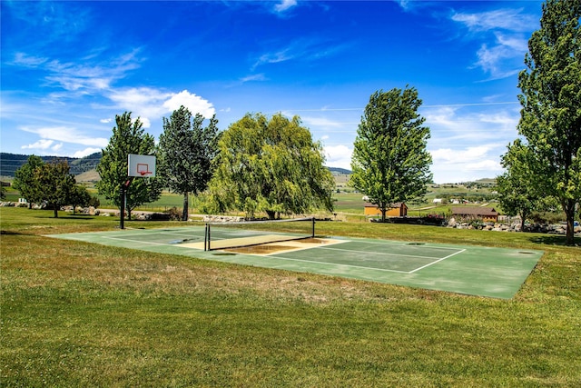 view of basketball court featuring a mountain view and a yard