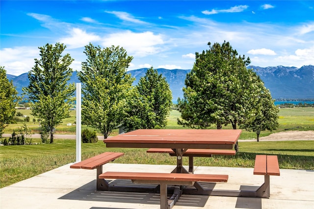 surrounding community featuring a mountain view and a yard