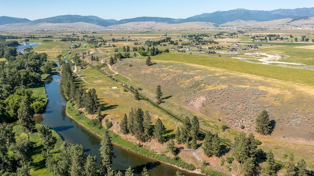 aerial view featuring a water and mountain view and a rural view