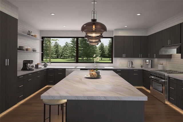 kitchen with pendant lighting, stainless steel appliances, a kitchen island, and tasteful backsplash