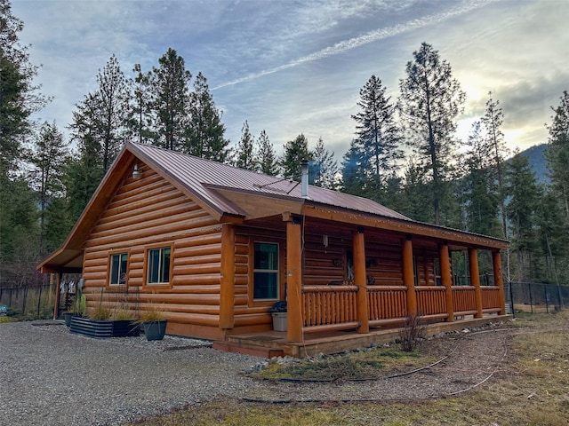 property exterior at dusk with covered porch