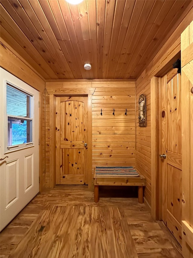 mudroom with wooden ceiling, light hardwood / wood-style flooring, and wood walls