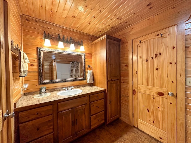 bathroom with wooden ceiling, wood walls, and vanity