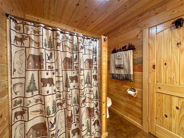 bathroom featuring toilet, wooden ceiling, and wood walls