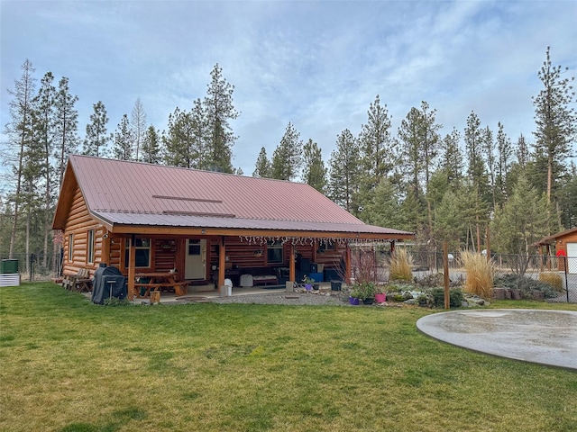 back of house with a lawn and a patio