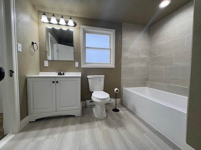 full bathroom featuring vanity, toilet, and tiled shower / bath