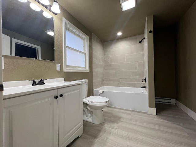 full bathroom with vanity, toilet, tiled shower / bath, and a baseboard radiator