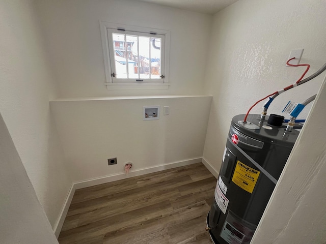 washroom with hookup for an electric dryer, electric water heater, dark wood-type flooring, and washer hookup