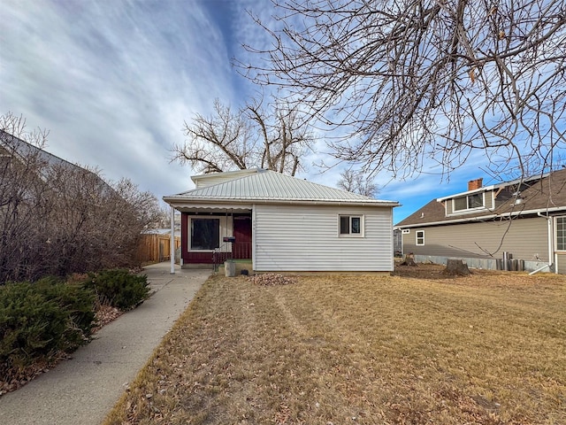 back of property featuring a lawn