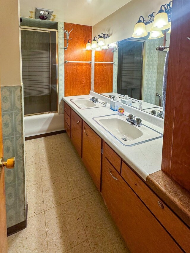 bathroom with vanity and bath / shower combo with glass door