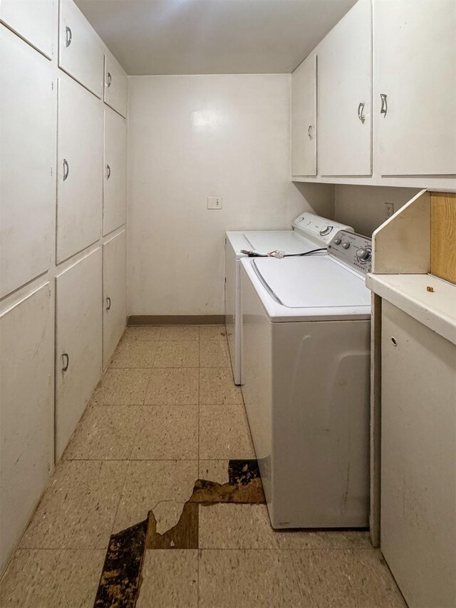 laundry room featuring washing machine and dryer and cabinets