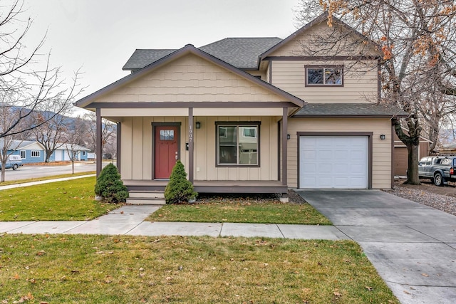 view of front facade featuring a front yard, a garage, and covered porch