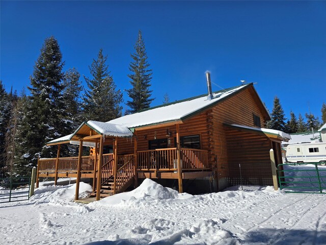 view of snow covered rear of property