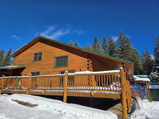 snow covered property featuring a deck