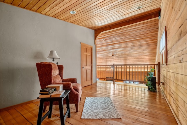 sitting room featuring hardwood / wood-style flooring and wood ceiling