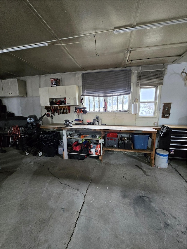 garage featuring electric panel and a workshop area