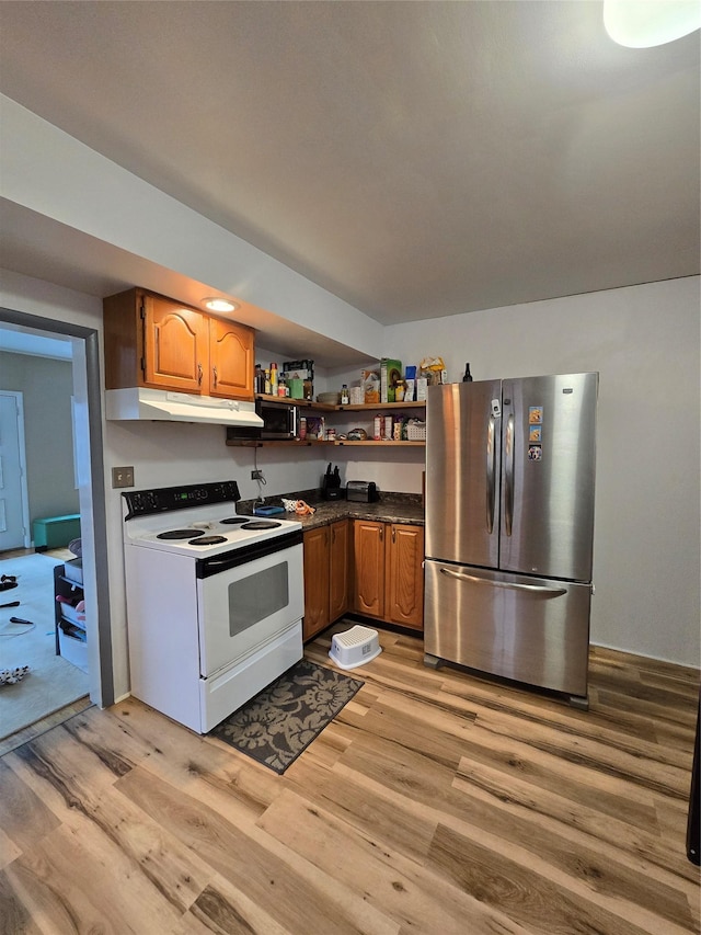 kitchen with white electric range, stainless steel refrigerator, and light wood-type flooring