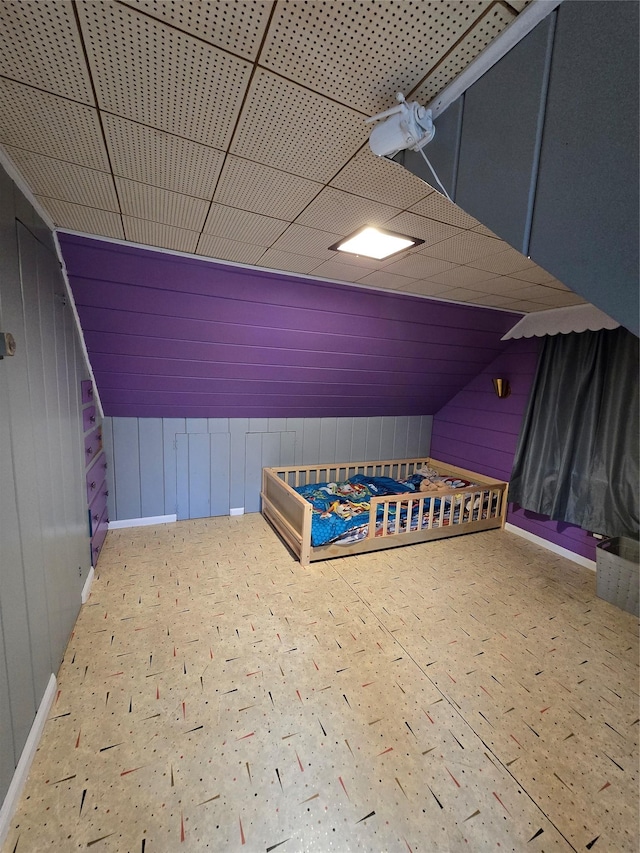 interior space with lofted ceiling and wooden walls