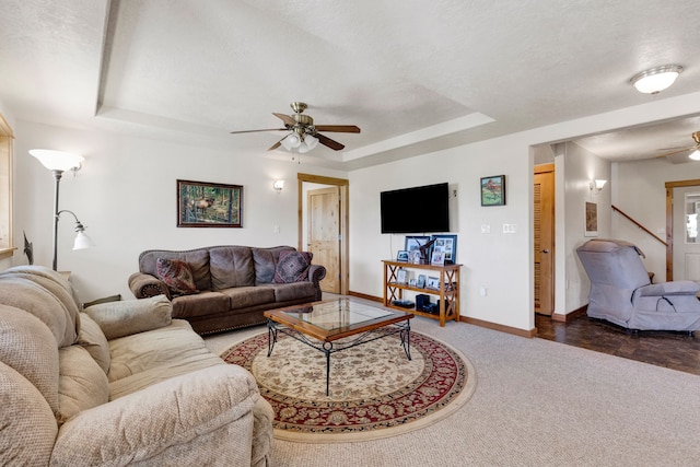 358 Hamilton Heights Rd, Corvallis, MT 59828 - carpeted living area featuring baseboards, ceiling fan, and a tray ceiling