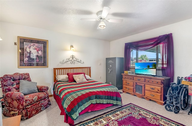 carpeted bedroom with a textured ceiling and ceiling fan