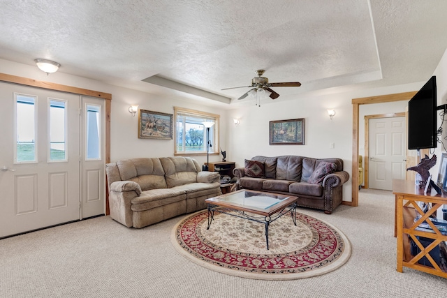 358 Hamilton Heights Rd, Corvallis, MT 59828 - carpeted living area featuring a raised ceiling, a textured ceiling, and ceiling fan